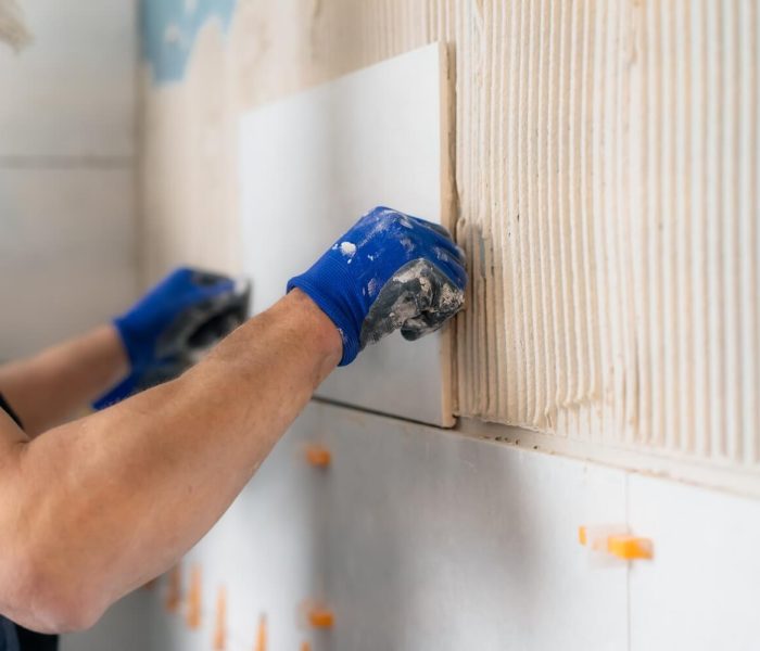 man-laying-tiles-on-a-bathroom-wall-diy-concept-2023-11-27-05-23-15-utc (1)